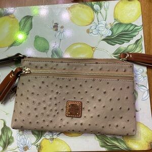 Dooney Bourke clutch, Six card slots, zipper pocket outsole with tassel . New